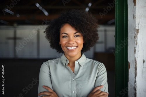 Portrait of a blissful afro-american woman in her 40s donning a classy polo shirt against a empty modern loft background. AI Generation