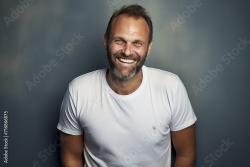 Portrait of a grinning man in his 40s sporting a vintage band t-shirt against a plain white digital canvas. AI Generation