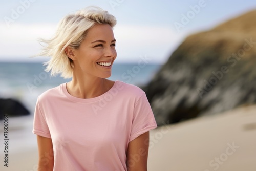 Close up portrait of beautiful blond woman posing on the beach in sunset light. Summer tropical mood.