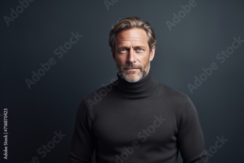 Portrait of a happy man in his 50s wearing a classic turtleneck sweater against a bare monochromatic room. AI Generation