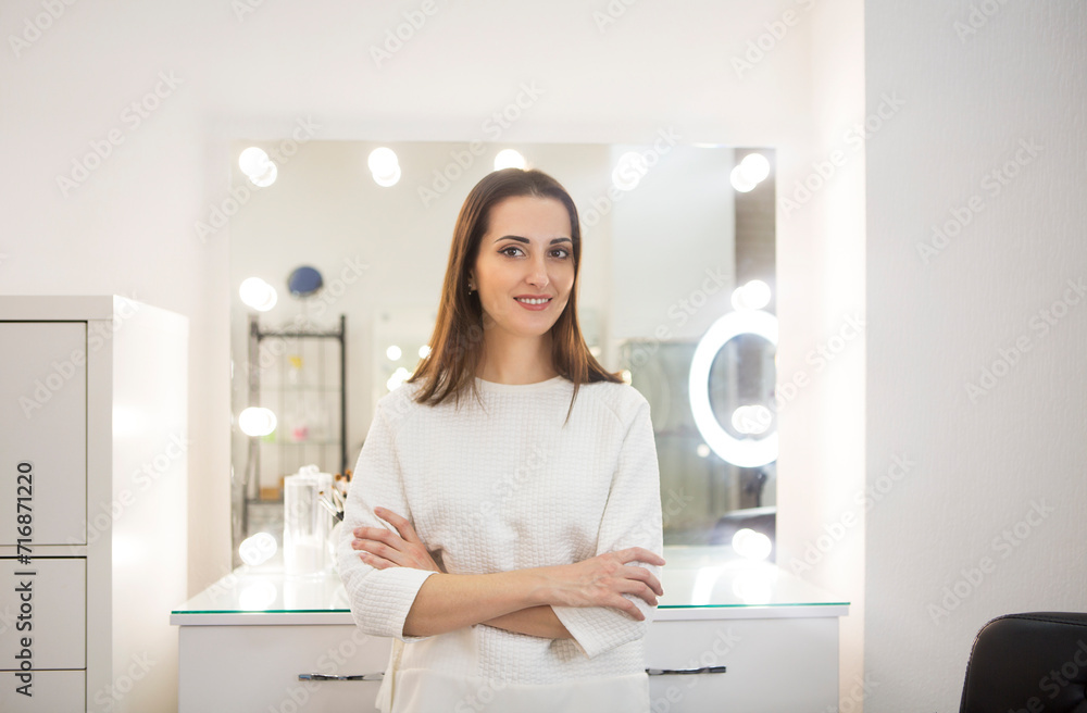 Make up artist by the mirror in her studio Make up artist by the mirror in her studio