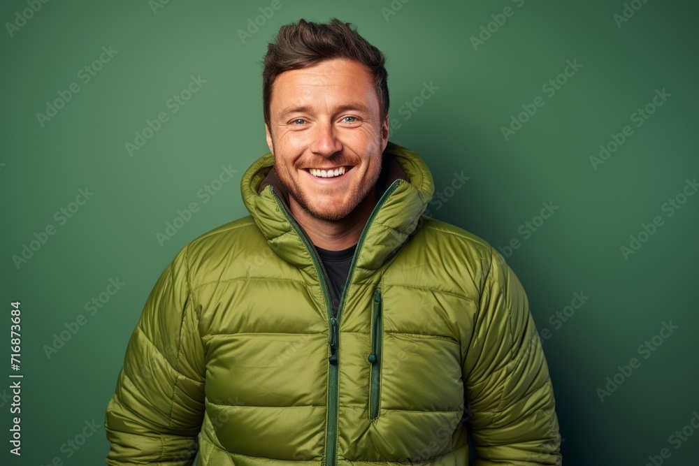 Portrait of a smiling man in his 30s donning a durable down jacket against a plain cyclorama studio wall. AI Generation Portrait of a smiling man in his 30s donning a durable down jacket against a plain cyclorama studio wall. AI Generation