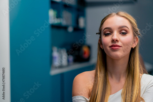 portrait of a satisfied smiling girl after an evening make-up procedure in a beauty salon