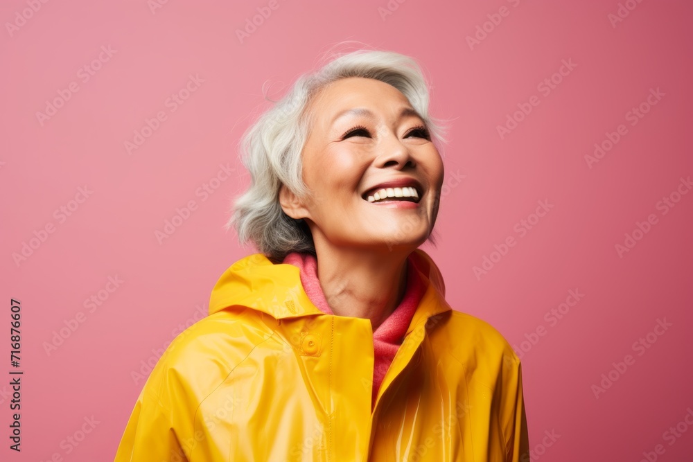 Portrait of a joyful woman in her 60s wearing a vibrant raincoat against a crisp minimalistic living room. AI Generation Portrait of a joyful woman in her 60s wearing a vibrant raincoat against a crisp minimalistic living room. AI Generation