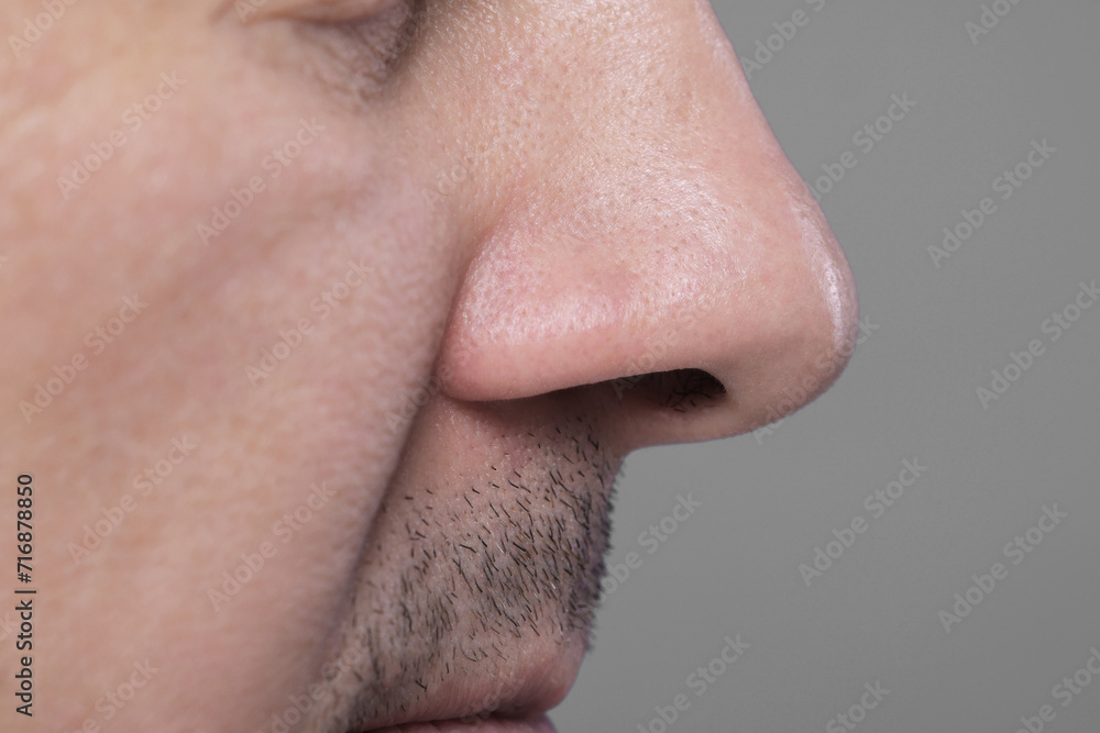 Closeup view of man with normal skin on grey background Closeup view of man with normal skin on grey background