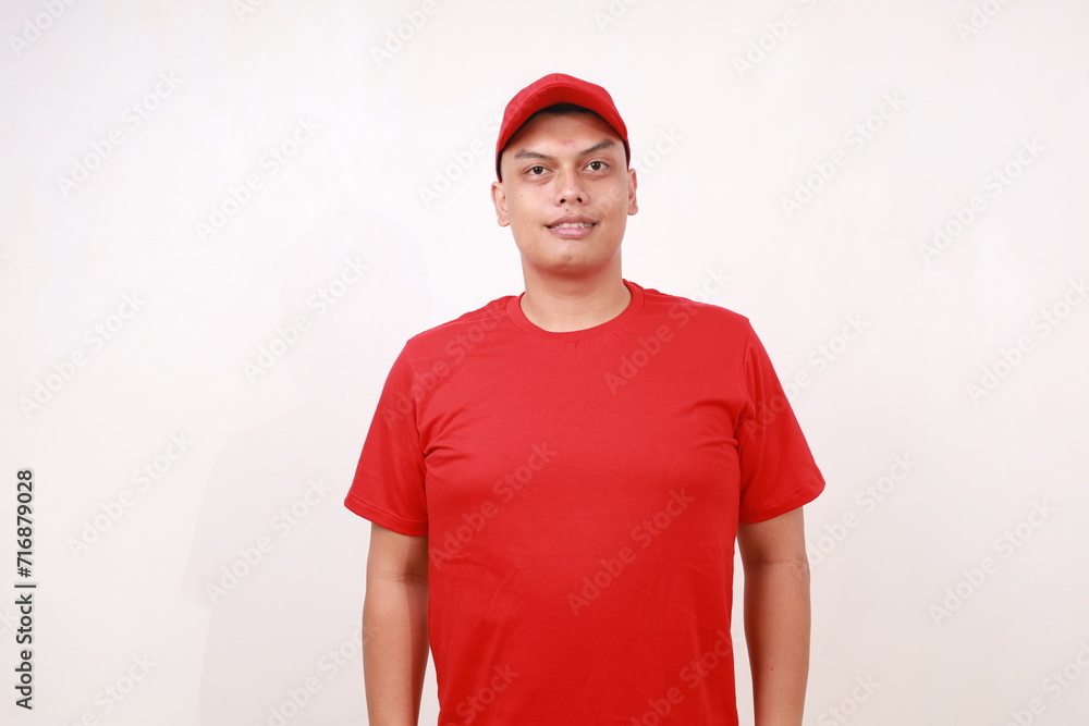 Handsome young asian courier standing while smiling against white background Handsome young asian courier standing while smiling against white background
