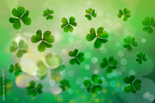 St. Patrick's Day celebration. Clover leaves on green background, bokeh effect