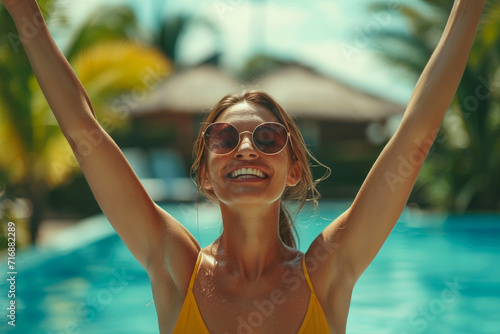 Sun-Kissed Bliss: Young Woman Celebrates by the Pool © Andrii 