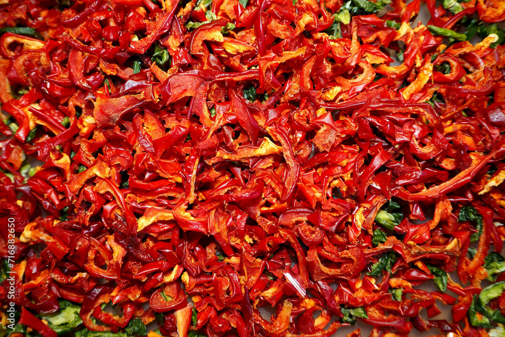 a lot of dried and sliced ​​red sweet bell peppers and a little green. view from above. food