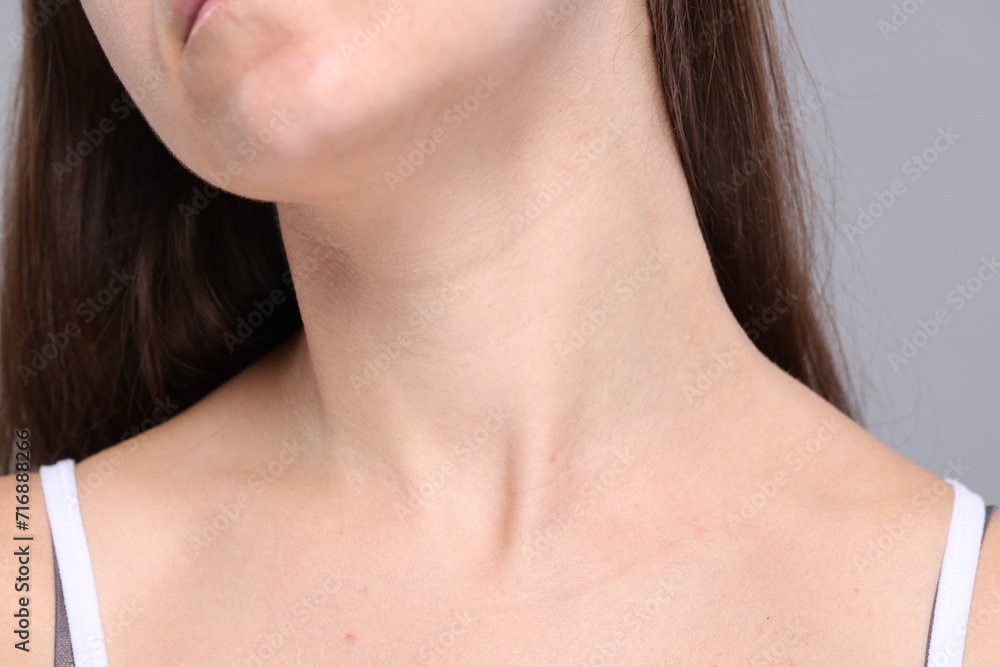 Closeup view of woman with normal skin on grey background Closeup view of woman with normal skin on grey background