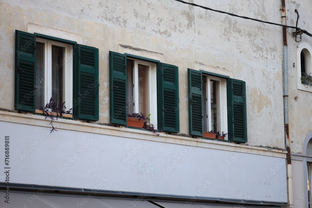 Old residential building with windows and wooden shutters