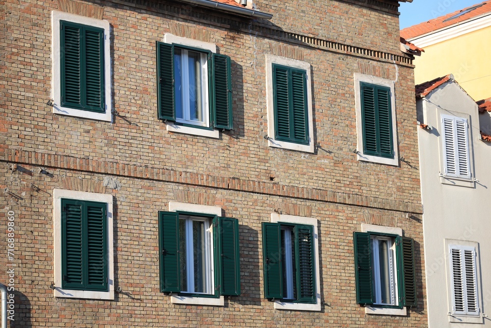 Exterior of old residential buildings with windows and wooden shutters Exterior of old residential buildings with windows and wooden shutters