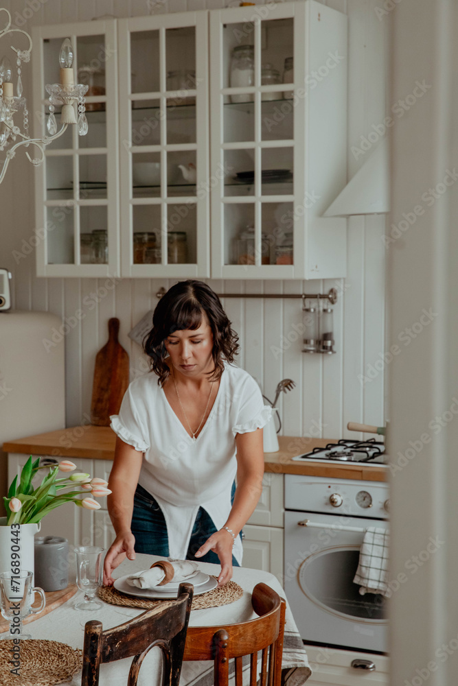 Beautiful girl with dark hair in the kitchen cooking food Beautiful girl with dark hair in the kitchen cooking food