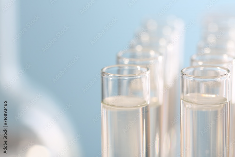 Laboratory analysis. Many glass test tubes on blurred background, closeup and space for text Laboratory analysis. Many glass test tubes on blurred background, closeup and space for text