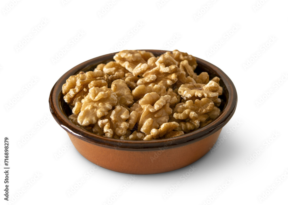 Walnuts in a baked clay dish isolated on empty background Walnuts in a baked clay dish isolated on empty background