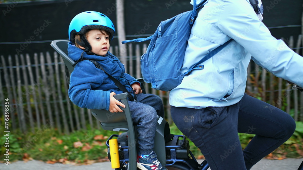 Mother Cycling with Child in Backseat Wearing Helmet, Autumn Bike Ride