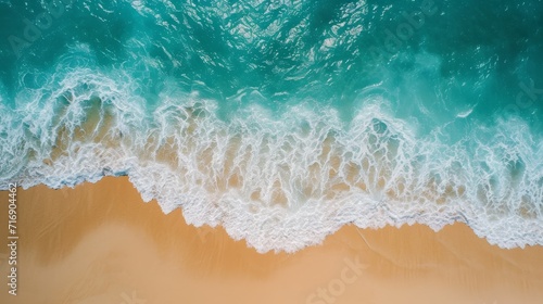 Top aerial view of a sandy beach with gentle waves background © furyon