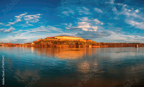 View of Petrovaradin fortress on Danube riverbank in Novi Sad. Famous tourist landmark in heart of serbian province of Vojvodina on sunny day. photo