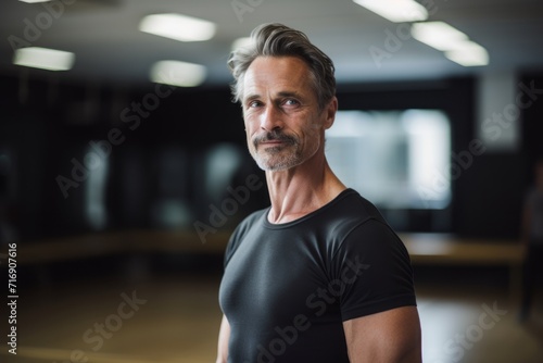 Portrait of a handsome mature man practicing ballet in a studio. With generative AI technology