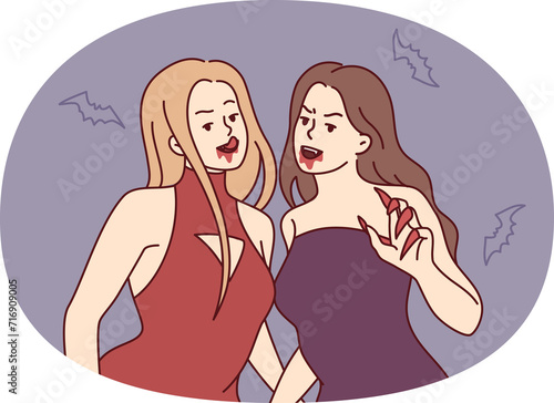 Women vampires in evening dresses with sharp claws and traces of blood near mouth. Vector image