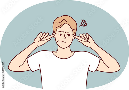 Offended guy closes ears does not want to hear toxic words or insults from peers or girlfriend. Embarrassed man trying to get rid of noise or loud music played by rude neighbors.