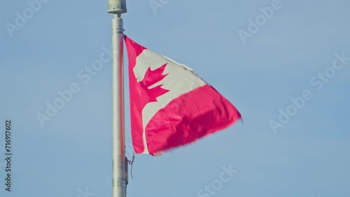 Canada country flag in wind blue sky