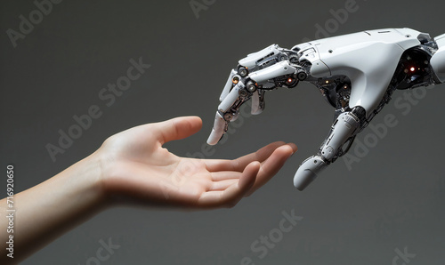 A human hand is reaching for a robotic AI futuristic technology hand. Artificial intelligence concept. Technology meets nature. Machine learning © Denis