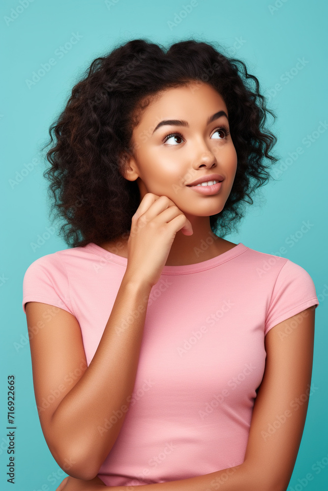 Photo of admiring young pretty African American girl brown hair wear pink crop top touch finger chin dreams look novelty isolated on cyan color background Photo of admiring young pretty African American girl brown hair wear pink crop top touch finger chin dreams look novelty isolated on cyan color background