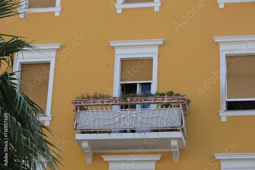 View of beautiful yellow building with balcony outdoors