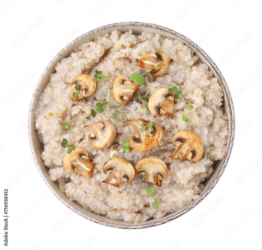 Delicious barley porridge with mushrooms and microgreens in bowl isolated on white, top view