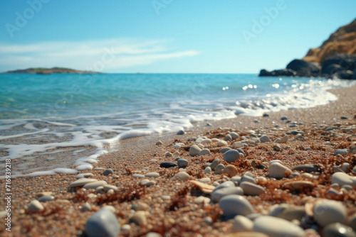 a beach with small pebbles scattered around and the sea in the background