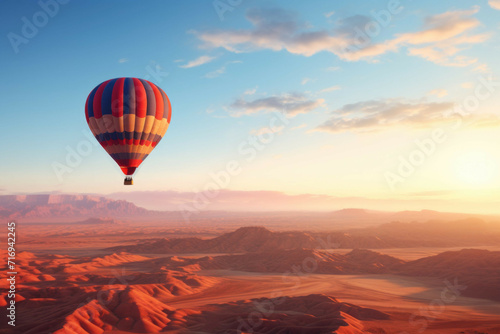 Hot air balloon over desert landscape at dawn