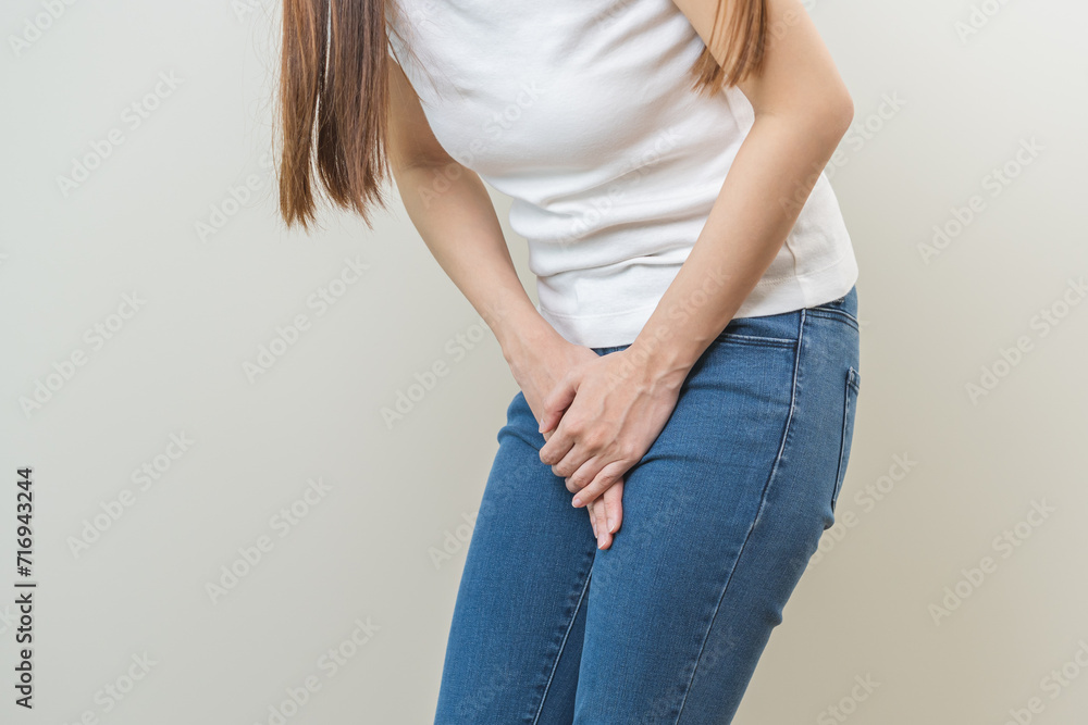 Vaginal, urinary incontinence. Pain asian young woman hand holding crotch suffering from pain, itchy or scratch of vagina, genital itching from infection. Gynecological problems menstrual disorder Vaginal, urinary incontinence. Pain asian young woman hand holding crotch suffering from pain, itchy or scratch of vagina, genital itching from infection. Gynecological problems menstrual disorder