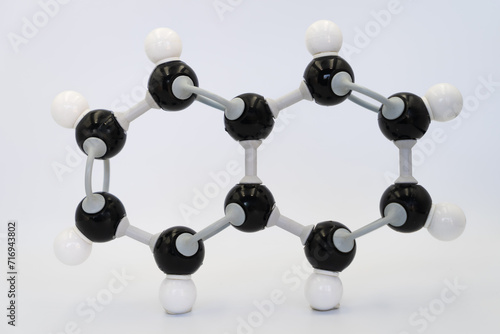 Naphthalene (or naphthalin) molecule made by molecular model on white background. Chemical formula with colored atoms and bonds photo