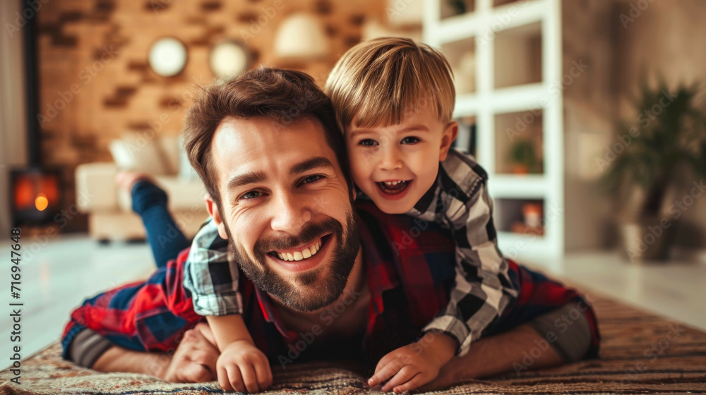 Happy loving daddy and cute boy playing active games at home. Family leisure concept Happy loving daddy and cute boy playing active games at home. Family leisure concept