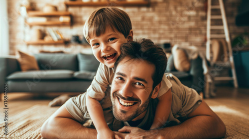 Happy loving daddy and cute boy playing active games at home. Family leisure concept photo
