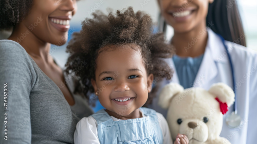 young girl with curly hair holding a teddy bear, accompanied by a female healthcare professional young girl with curly hair holding a teddy bear, accompanied by a female healthcare professional