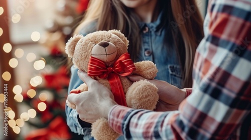 A girl giving cute teddy bear gift to his boyfriend, but just showing their hands, on valentine day