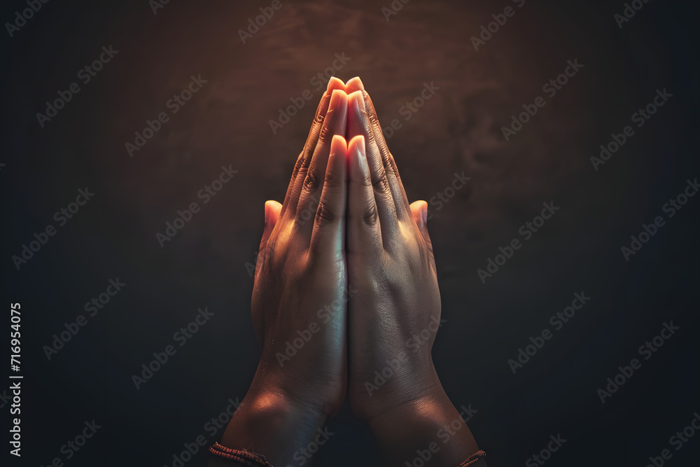Praying hands with faith in religion and belief in God on dark ...
