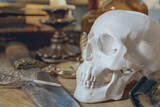 Human skull with a combat knife. The symbol of the head of death with a knife, the candle is a dying life.