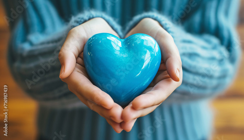 Happy Moments  Woman Holding Blue Heart for Health and Wellness