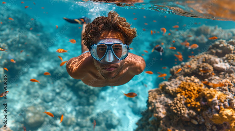 man snorkeling in crystal clear tropical sea man snorkeling in crystal clear tropical sea
