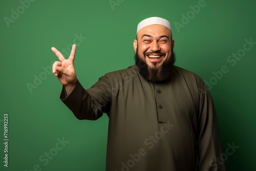 a muslim man poses greetings on green background with generative ai