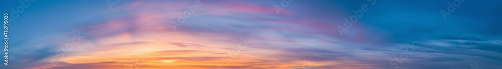 Purple and pink hues in a Vibrant extra wide panoramic sky. Fantasy banner sky. Rich colors. Daytime sunset beauty. Fiery glowing heavenly sky with gradient colors. Red, pink, orange, blue, yellow.