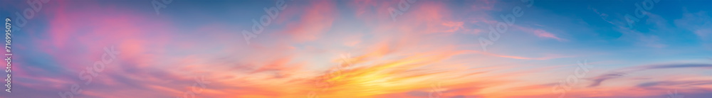 Vibrant extra wide panoramic sky. Fantasy banner sky. Rich colors. Daytime sunset beauty. Fiery glowing heavenly sky with gradient colors. Red, pink, orange, blue, yellow. soft clouds