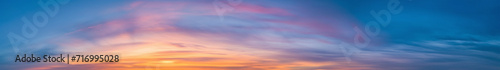 Purple and pink hues in a Vibrant extra wide panoramic sky. Fantasy banner sky. Rich colors. Daytime sunset beauty. Fiery glowing heavenly sky with gradient colors. Red, pink, orange, blue, yellow. © ana