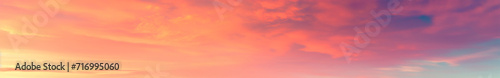 Vibrant extra wide panoramic sky. Fantasy banner sky. Rich colors. Daytime sunset beauty. Fiery glowing heavenly sky with gradient colors. Red, pink, orange, blue, yellow. Red fiery sunrise