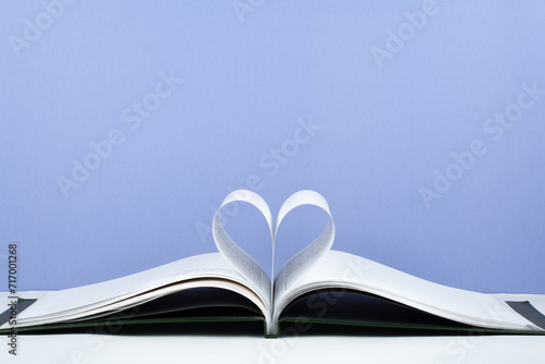 Old open hardback book, page decorate into a heart shape for love in Valentine's. love with open book heart.