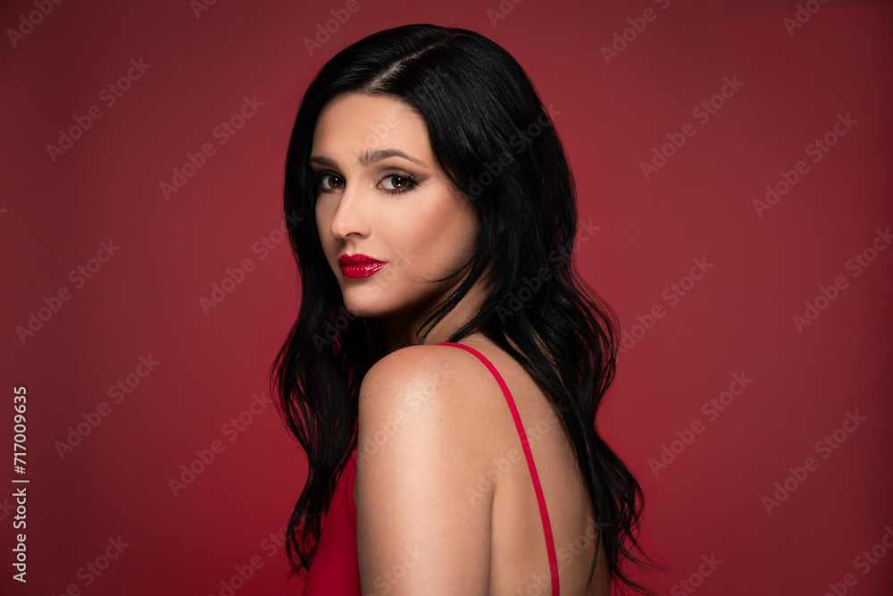 Beauty studio portrait of young beautiful woman against red background. Beauty studio portrait of young beautiful woman against red background.