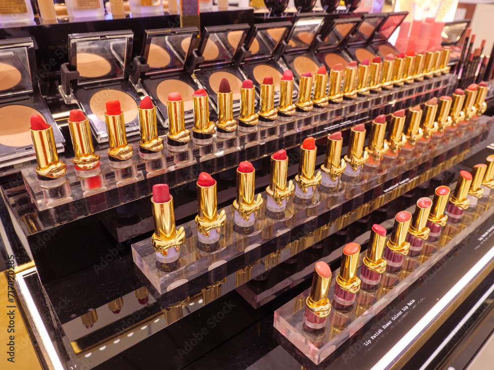 Rows of shades of red lipstick makeup on the cosmetics counter of a beauty products concession of a department store Rows of shades of red lipstick makeup on the cosmetics counter of a beauty products concession of a department store